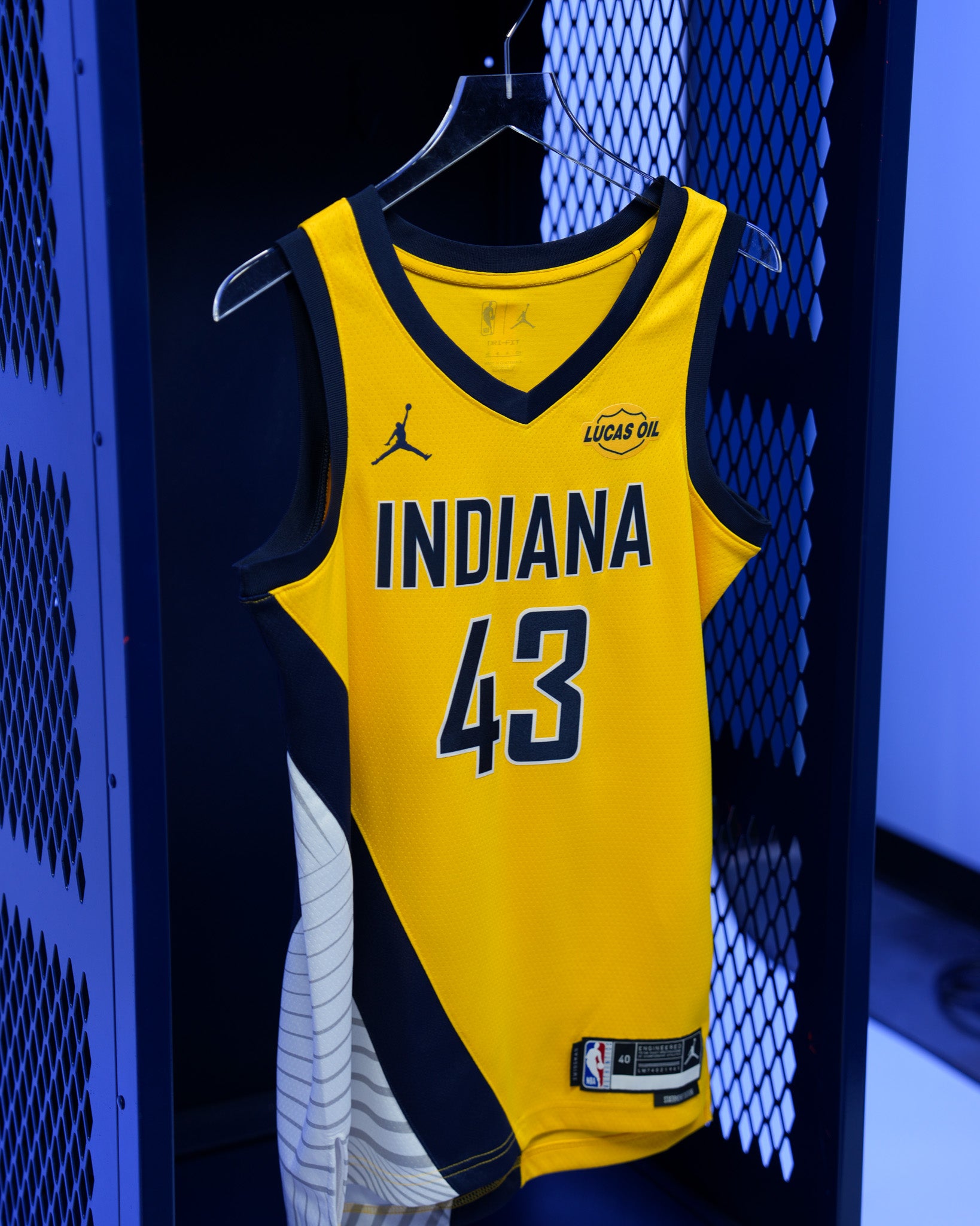 Yellow basketball jersey with 'Indiana' and number '43' hanging in a locker.
