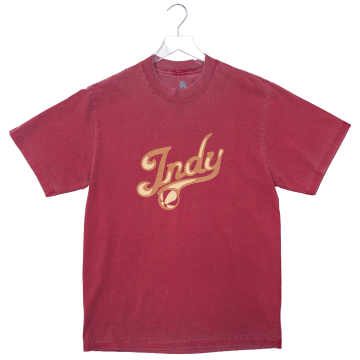 Red t-shirt with 'Indy' printed in gold on a white background