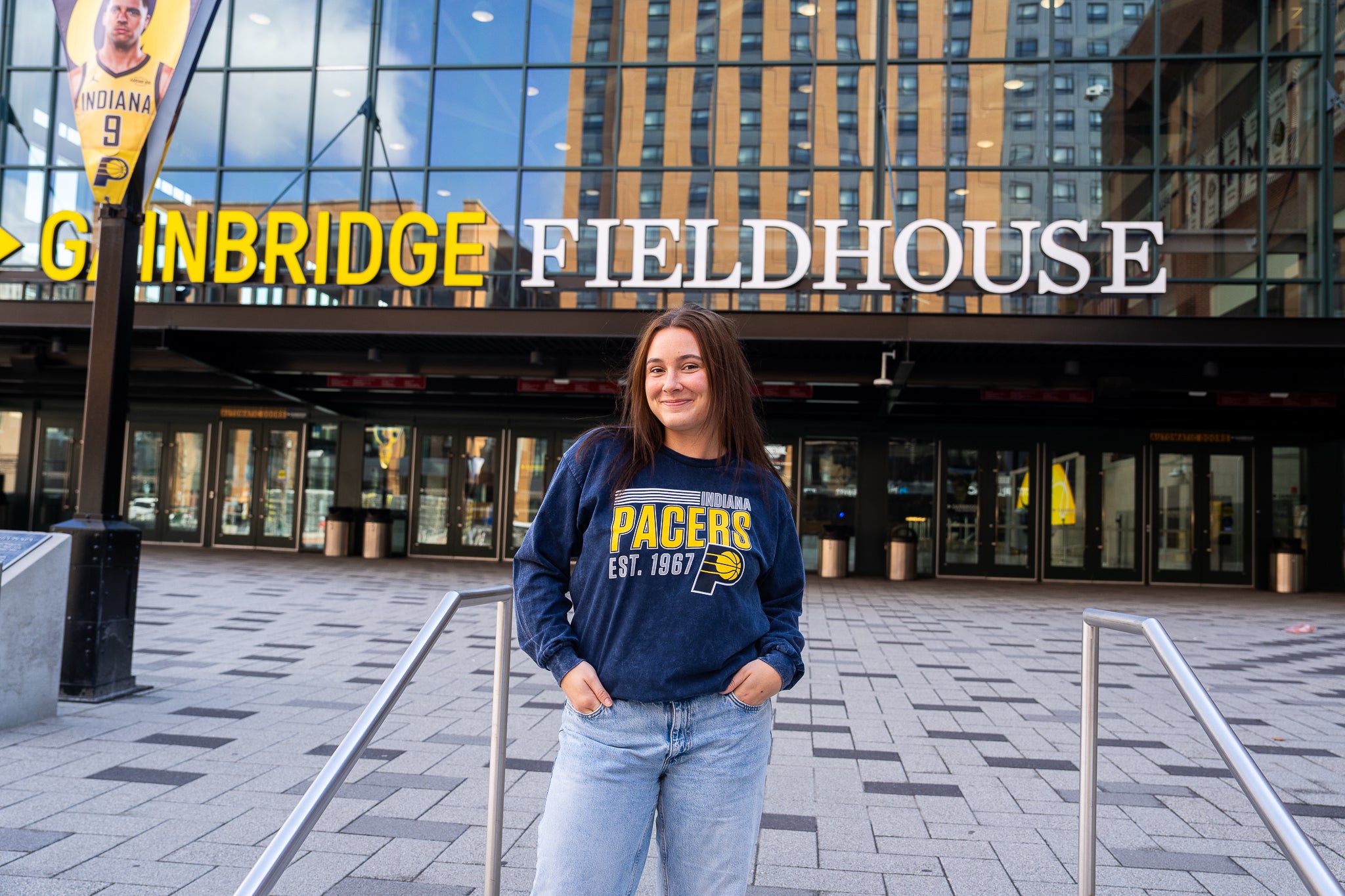 Person wearing a Pacers sweatshirt in front of the Bankers Life Fieldhouse.