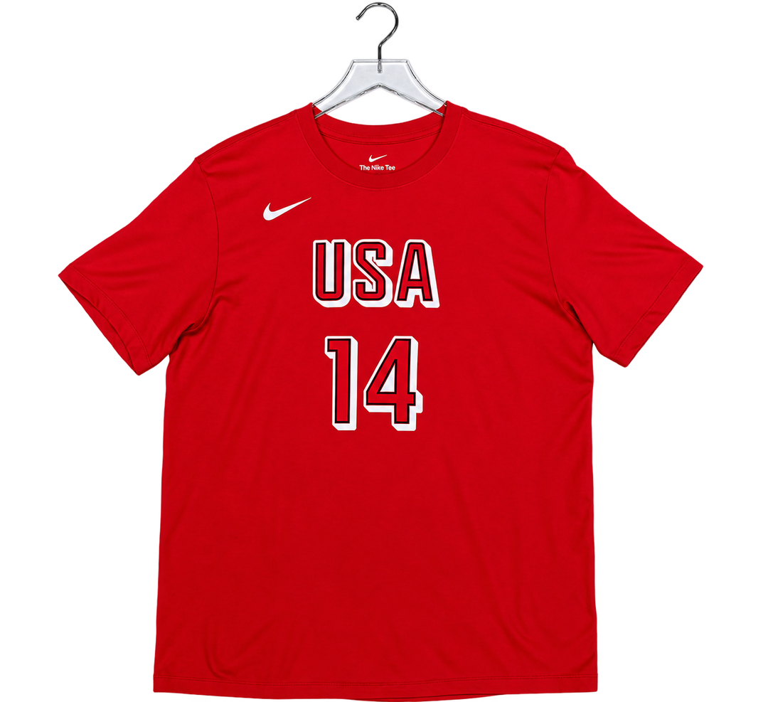 A red short-sleeve athletic T-shirt hanging on a clear plastic hanger against a white background. The shirt features a white Nike swoosh on the left chest and 'USA 14' printed in white with a red outline on the front.