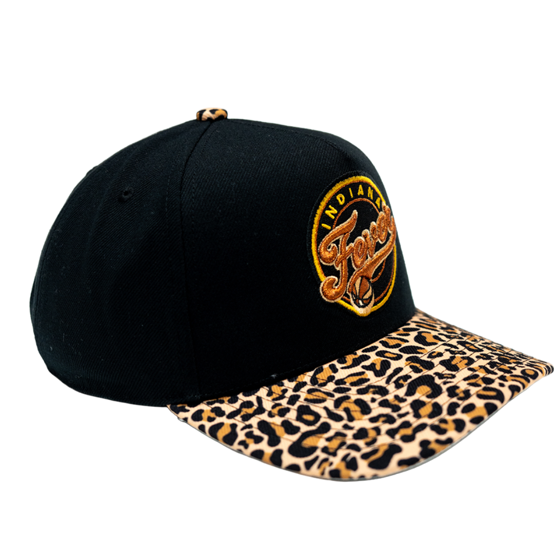 A black baseball cap with a leopard-print brim and a circular embroidered 'Indiana Pacers' logo on the front, shown against a plain white background.