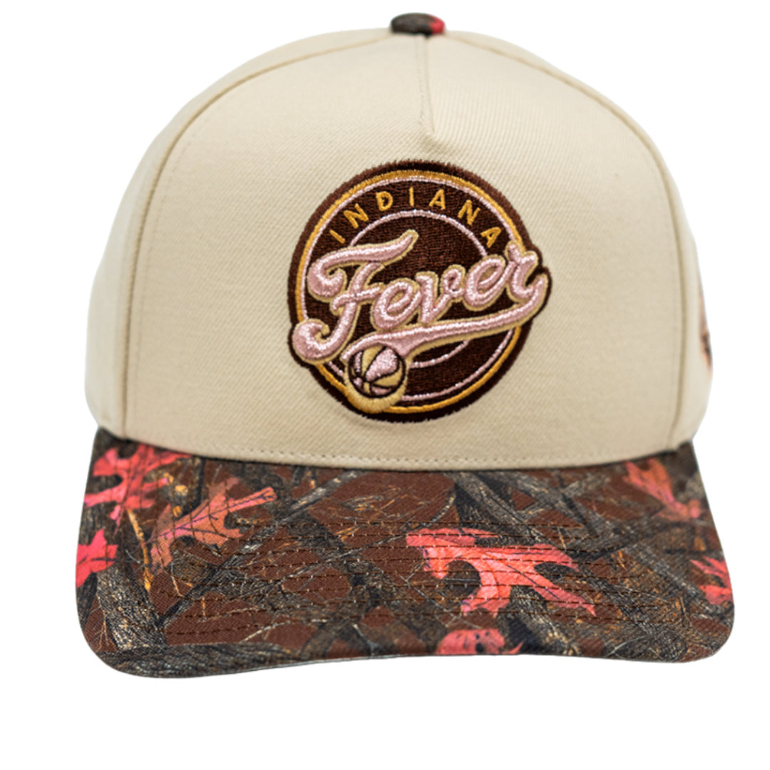 A beige snapback cap with a brown and red camouflage patterned brim, featuring an embroidered circular 'Indiana Fever' logo on the front.