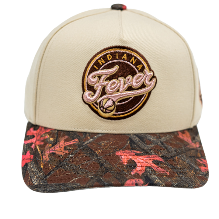A beige snapback cap with a brown and red camouflage patterned brim, featuring an embroidered circular 'Indiana Fever' logo on the front.