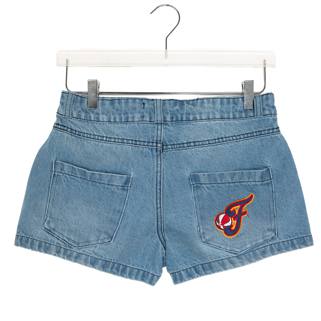 Blue denim shorts with a logo on a hanger against a white background