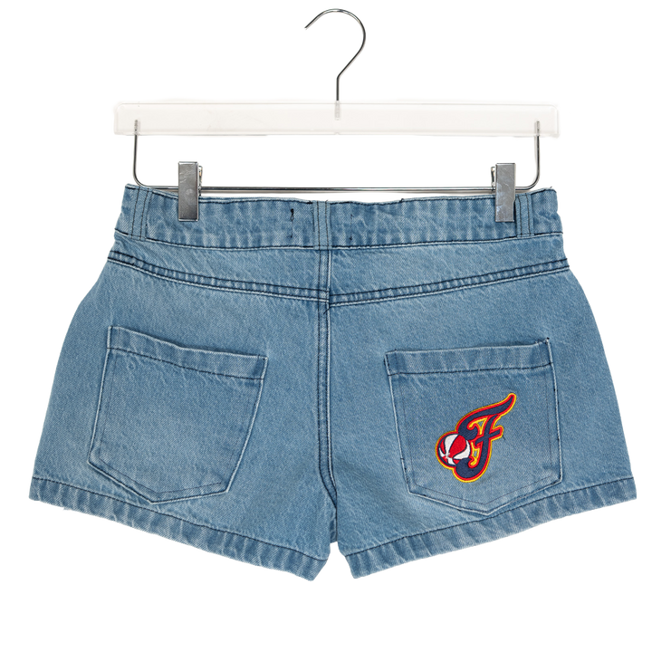Blue denim shorts with a logo on a hanger against a white background